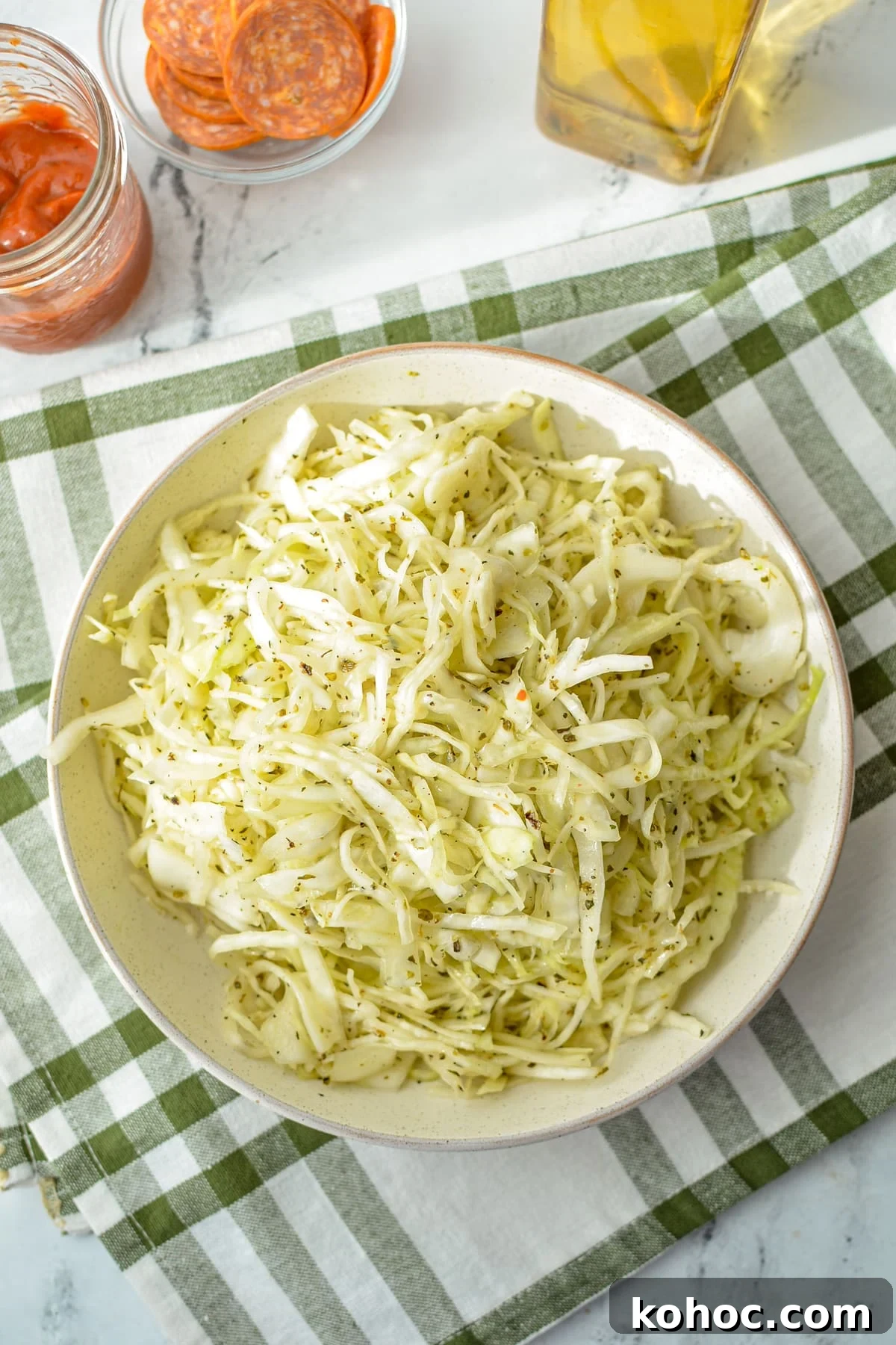 Swedish Pizza Salad: Tangy Cabbage Slaw with Dill 7 A bowl of shredded cabbage topped with an oil and vinegar dressing.