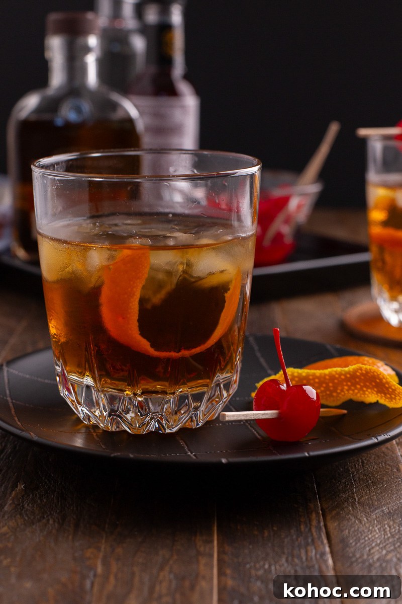 Classic Old Fashioned Cocktail Recipe with Bourbon 3 Old fashioned bourbon cocktail sitting on a plate.