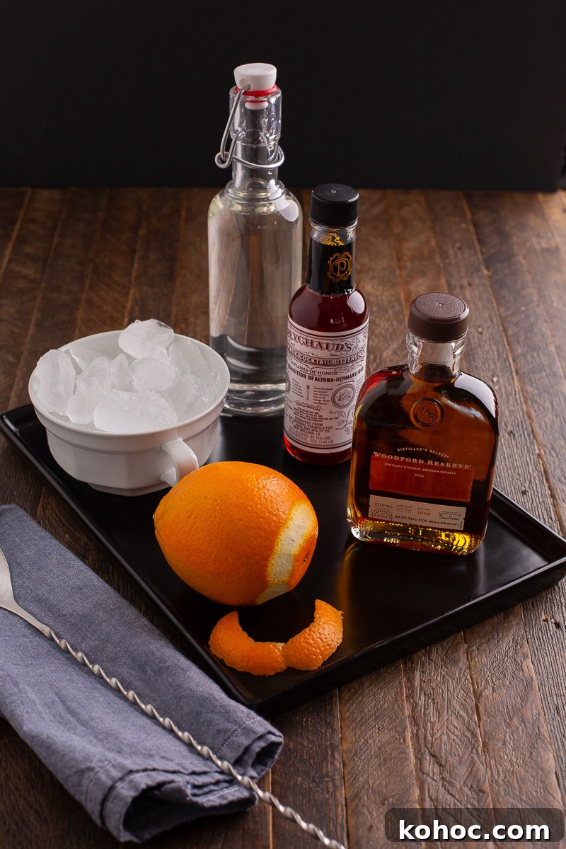 Classic Old Fashioned Cocktail Recipe with Bourbon 4 Ingredients for old fashioned cocktail on a wooden counter.