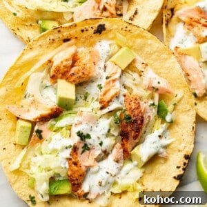 Crispy Baked Salmon Tacos with Lime Slaw 7 baked salmon tacos on a marble surface